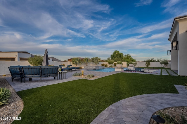 view of yard with a patio, an outdoor living space, and a fenced in pool