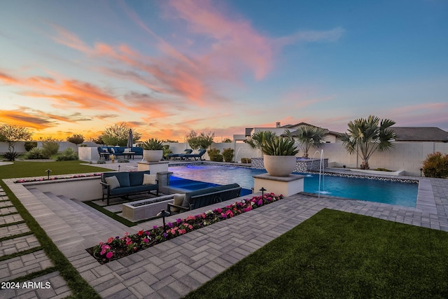 pool at dusk featuring a patio area, an outdoor living space, pool water feature, and a lawn