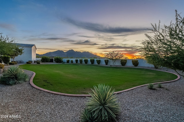 yard at dusk featuring a mountain view