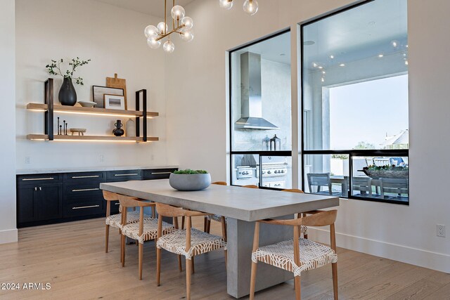 dining room featuring a notable chandelier and light wood-type flooring