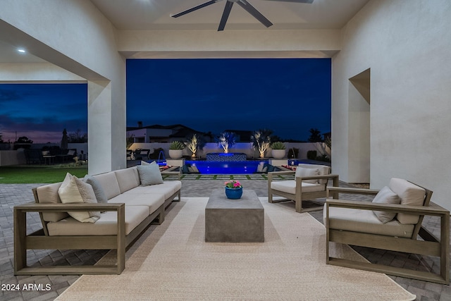 patio terrace at dusk featuring an outdoor living space