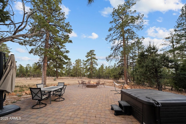 2702 Majestic Elk Rd, Overgaard, AZ 85933 - view of patio / terrace featuring a hot tub and an outdoor fire pit