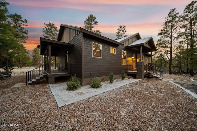2702 Majestic Elk Rd, Overgaard, AZ 85933 - property exterior at dusk with crawl space and board and batten siding
