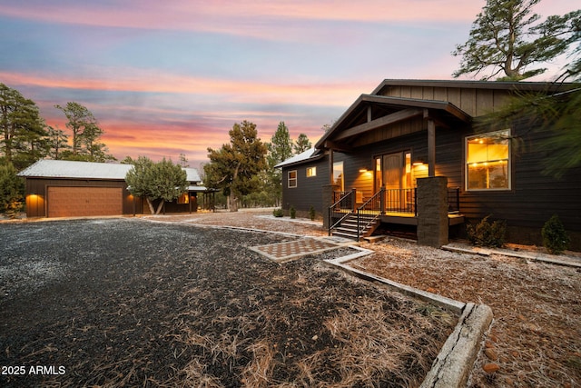2702 Majestic Elk Rd, Overgaard, AZ 85933 - exterior space with a garage, gravel driveway, board and batten siding, and an outbuilding