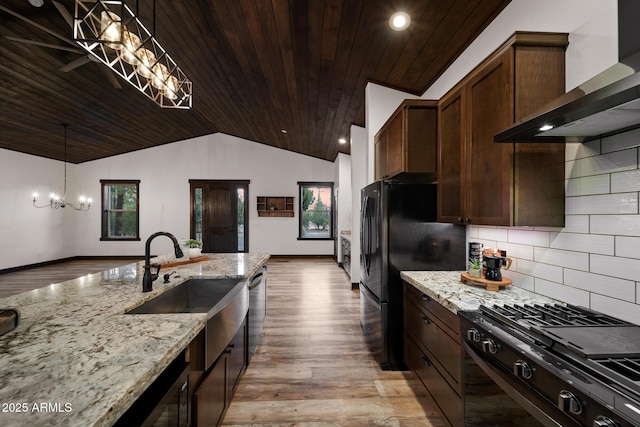 2702 Majestic Elk Rd, Overgaard, AZ 85933 - kitchen featuring light wood-type flooring, vaulted ceiling, an inviting chandelier, wall chimney exhaust hood, and wood ceiling