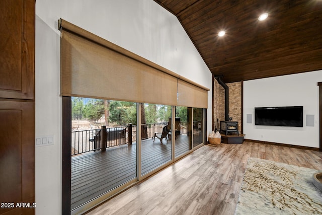 2702 Majestic Elk Rd, Overgaard, AZ 85933 - unfurnished living room featuring a wood stove, wood ceiling, recessed lighting, wood finished floors, and high vaulted ceiling