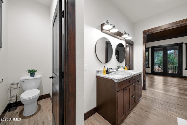 2702 Majestic Elk Rd, Overgaard, AZ 85933 - bathroom with toilet, wood finished floors, vanity, and baseboards