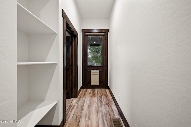 2702 Majestic Elk Rd, Overgaard, AZ 85933 - corridor featuring wood finished floors, a textured wall, baseboards, and visible vents