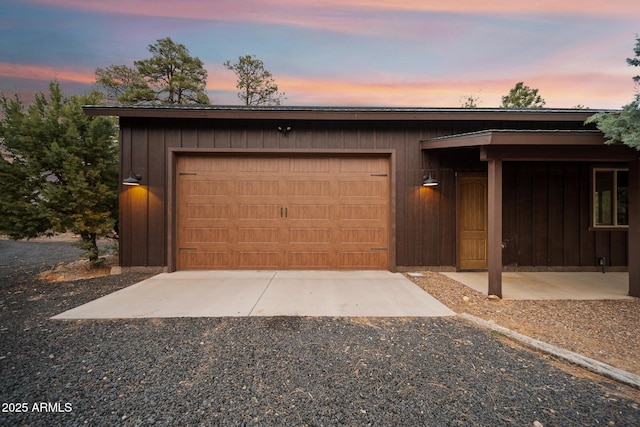 2702 Majestic Elk Rd, Overgaard, AZ 85933 - view of front of property with board and batten siding, a garage, and gravel driveway
