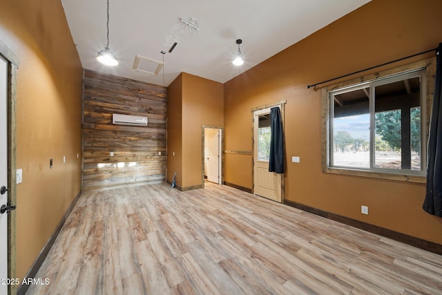2702 Majestic Elk Rd, Overgaard, AZ 85933 - empty room featuring wooden walls, light wood-style flooring, baseboards, and a wall unit AC