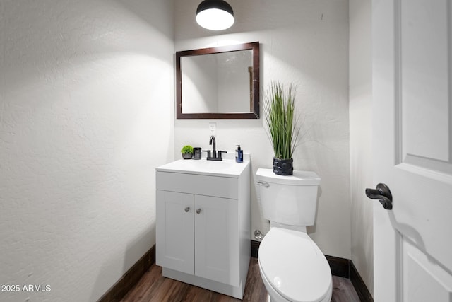 2702 Majestic Elk Rd, Overgaard, AZ 85933 - bathroom featuring toilet, vanity, wood finished floors, and baseboards