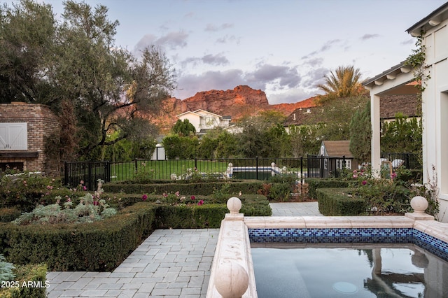 view of swimming pool featuring a patio area and fence