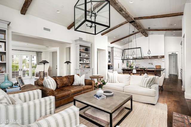 living room featuring dark wood-type flooring, french doors, beamed ceiling, and visible vents