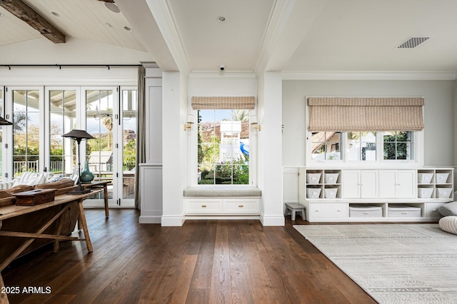 mudroom with dark wood-style floors, crown molding, visible vents, lofted ceiling with beams, and baseboards