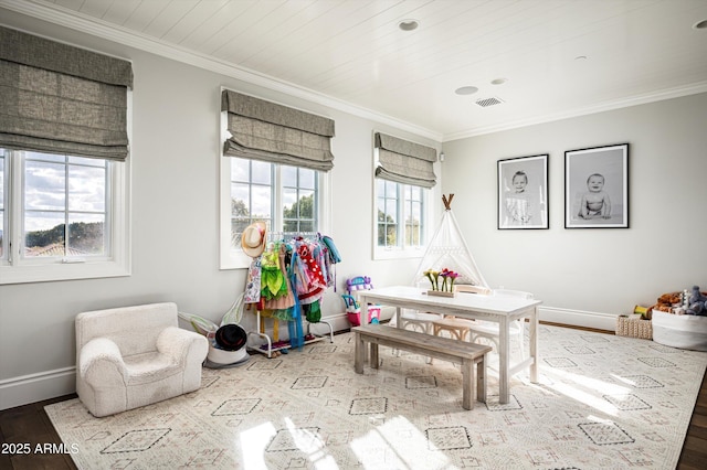 rec room featuring baseboards, visible vents, wood finished floors, and ornamental molding