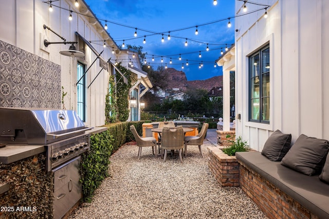 view of patio / terrace featuring outdoor dining space, area for grilling, and a mountain view