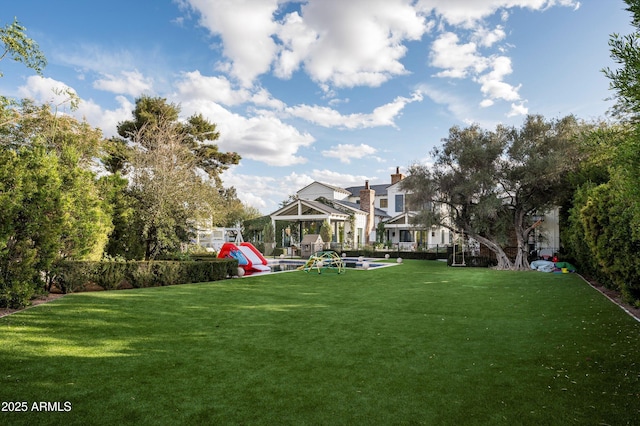 exterior space with a lawn and a playground