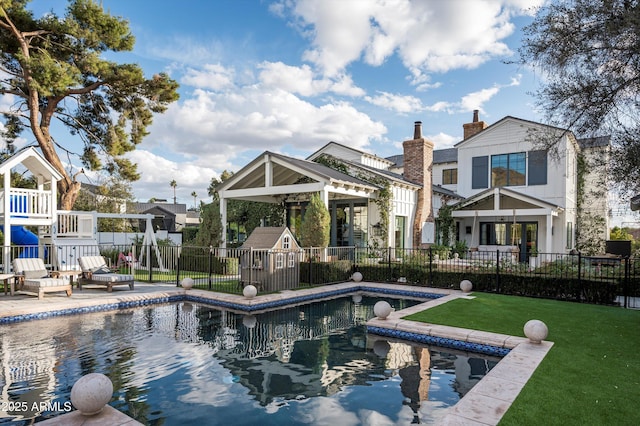 view of swimming pool featuring a fenced in pool, a playground, a lawn, and fence