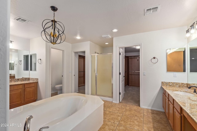 full bathroom featuring shower with separate bathtub, a chandelier, toilet, vanity, and tile patterned flooring