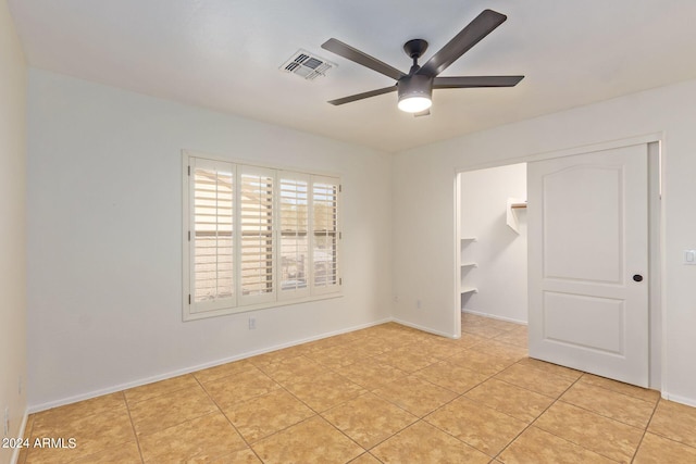 spare room with light tile patterned flooring and ceiling fan