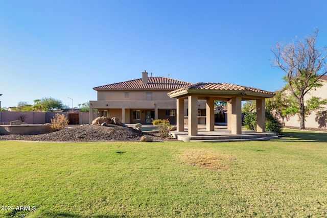 back of property featuring a patio area and a yard