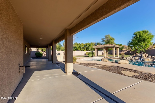 view of patio with a fenced in pool and a gazebo