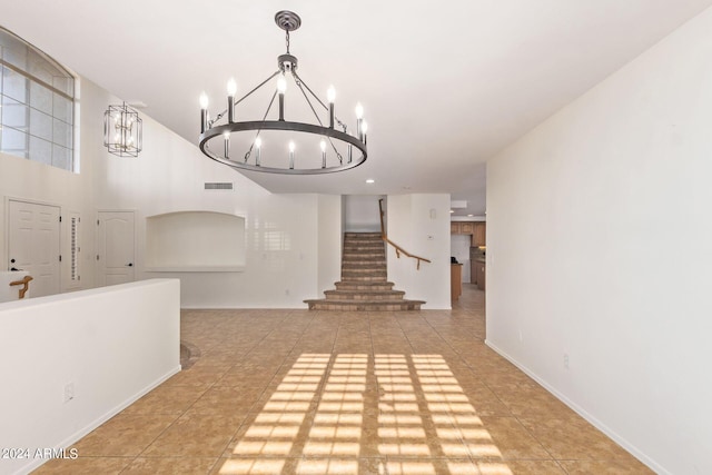 tiled foyer with a chandelier