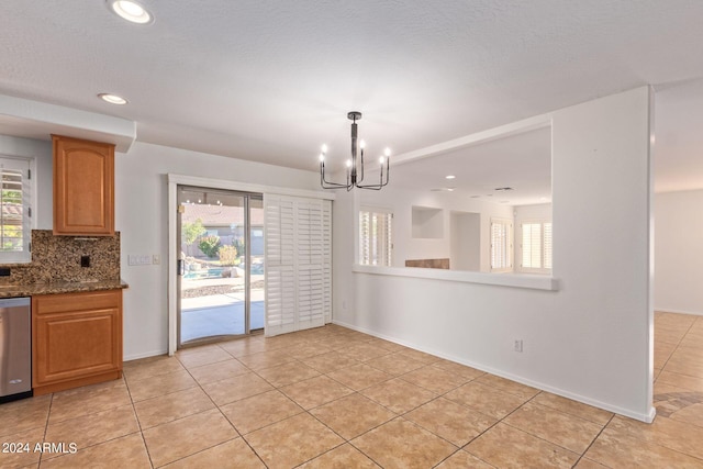 unfurnished dining area featuring a chandelier and light tile patterned floors