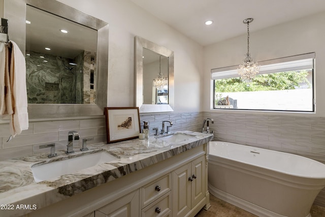 bathroom featuring tasteful backsplash, a notable chandelier, hardwood / wood-style floors, vanity, and independent shower and bath