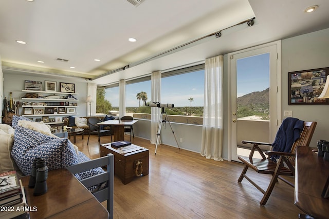 living room with hardwood / wood-style floors and a mountain view