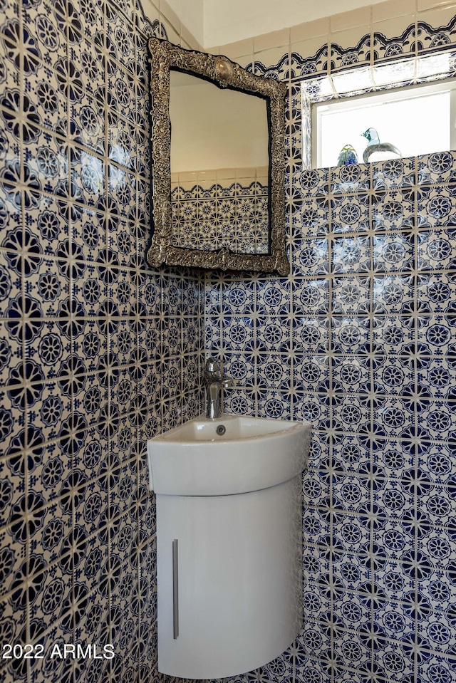 bathroom with tile walls