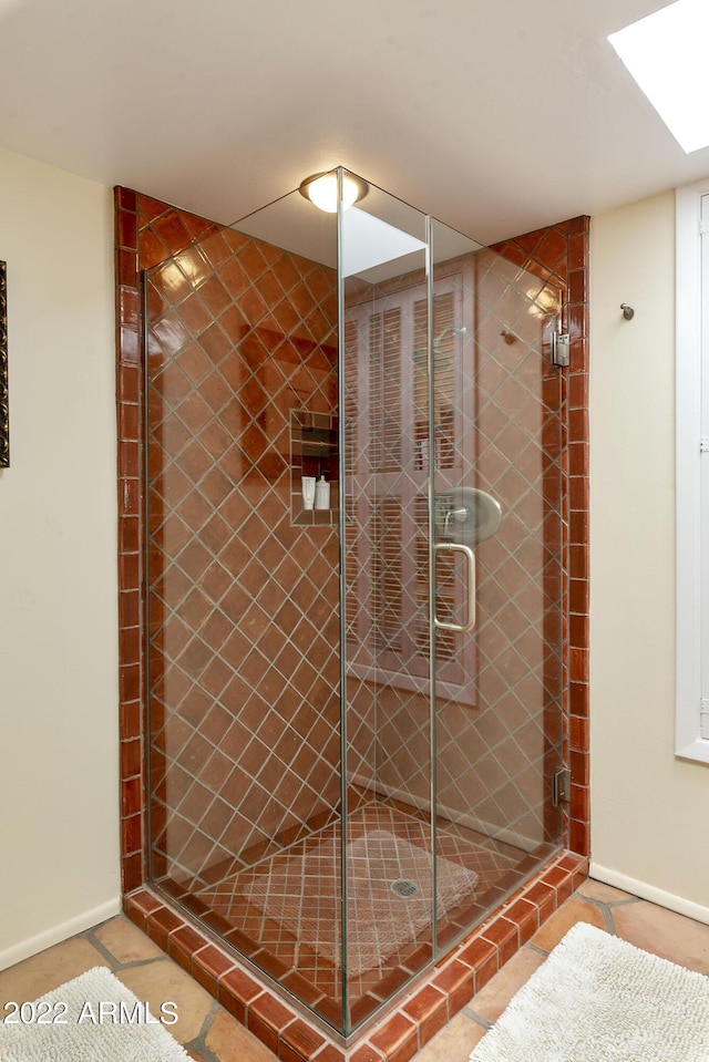 bathroom featuring tile patterned flooring and a shower with shower door