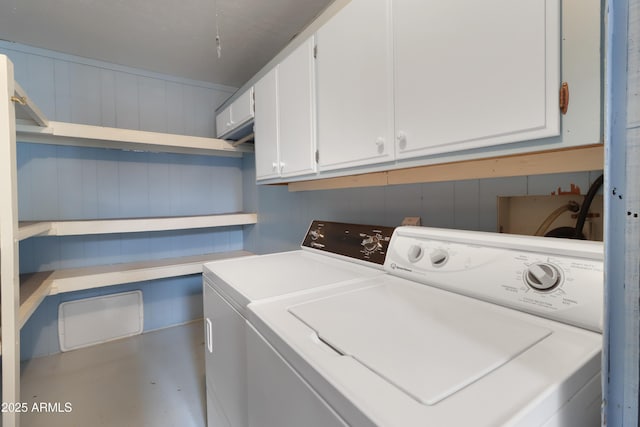 laundry room with cabinets and washer and clothes dryer