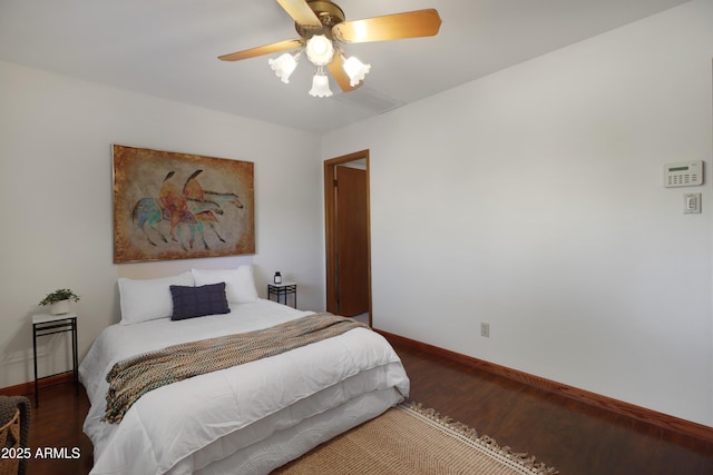 bedroom with ceiling fan and dark hardwood / wood-style flooring