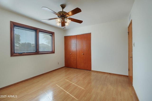 unfurnished bedroom with ceiling fan, light hardwood / wood-style floors, and a closet