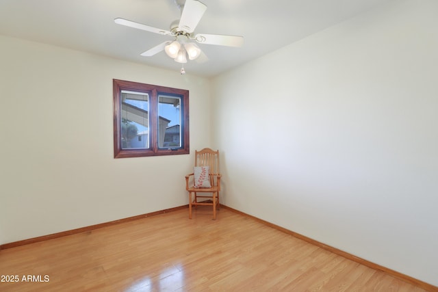 empty room with ceiling fan and light hardwood / wood-style flooring