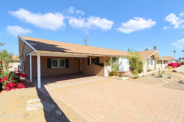 ranch-style house featuring a carport