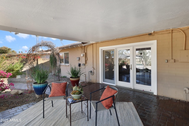 deck featuring electric panel and a patio area