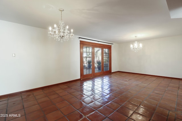 tiled spare room with french doors and a notable chandelier