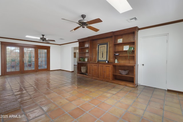 unfurnished living room with a skylight, tile patterned flooring, ornamental molding, ceiling fan, and french doors