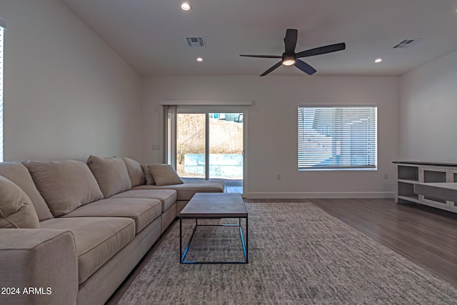 living room with ceiling fan and dark hardwood / wood-style flooring