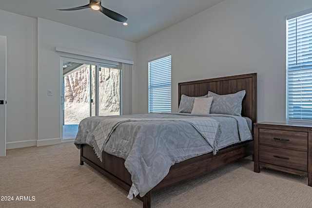 carpeted bedroom with multiple windows, access to exterior, and ceiling fan