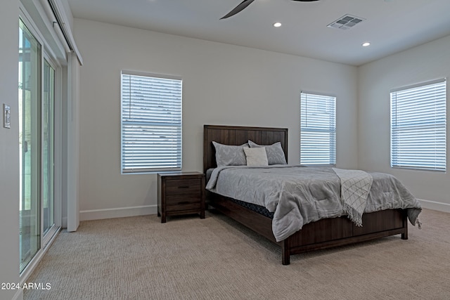 bedroom featuring light carpet, access to outside, and ceiling fan