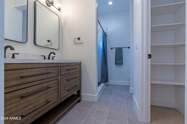 bathroom with vanity, curtained shower, and toilet