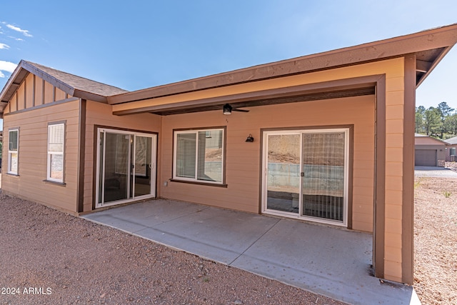 rear view of property with a patio and a garage