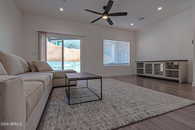 living room with ceiling fan and dark hardwood / wood-style flooring