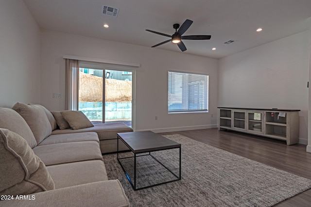 living room featuring dark hardwood / wood-style floors and ceiling fan