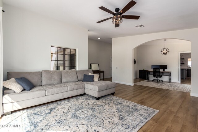 living room with wood-type flooring and ceiling fan