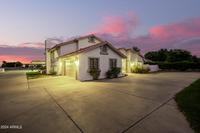 property exterior at dusk with a garage