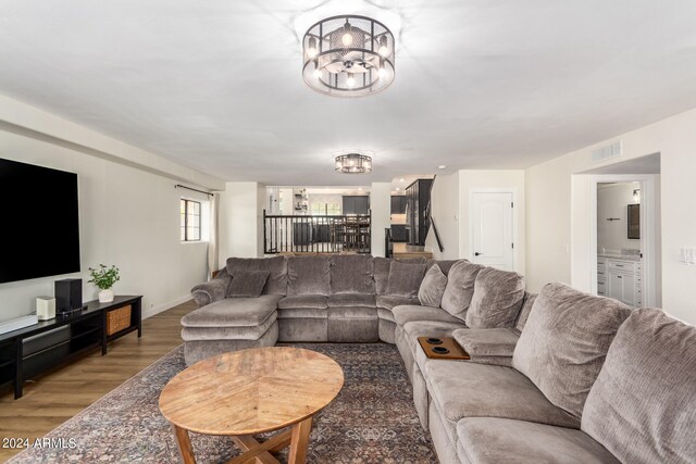 living room featuring hardwood / wood-style flooring and a chandelier